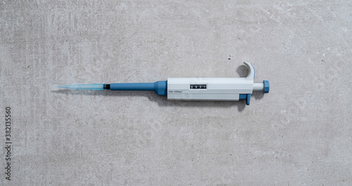 Automatic pipette on concrete background stock photo