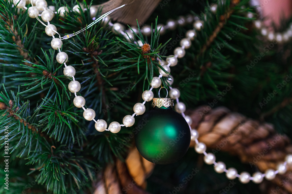 Decorations in Christmas tree - pearls and green Christmas ball