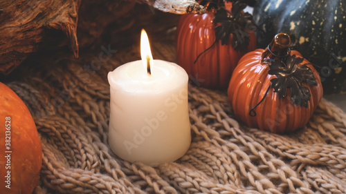 Autumn background with dry leaves, blue cup of coffee. Knitted background, pumpkins, October, November. Autumnal atmosphere. Autumn season.