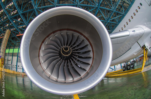Close up view of airplane turbine engine, wing and wheel of airplane.