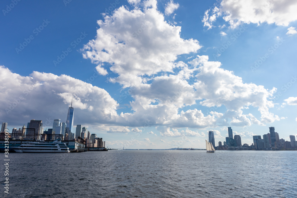Hudson River between the Lower Manhattan Skyline and Jersey City with a Beautiful Cloud Filled Sky during Summer