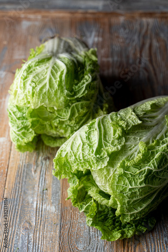 Two heads of of lettuce salad on kitchen table, close up, appetizing photo