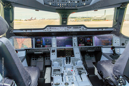 The image of cockpit interior and airplane cockpit view and blur background Airport building with traffic control tower and airplanes on runway
