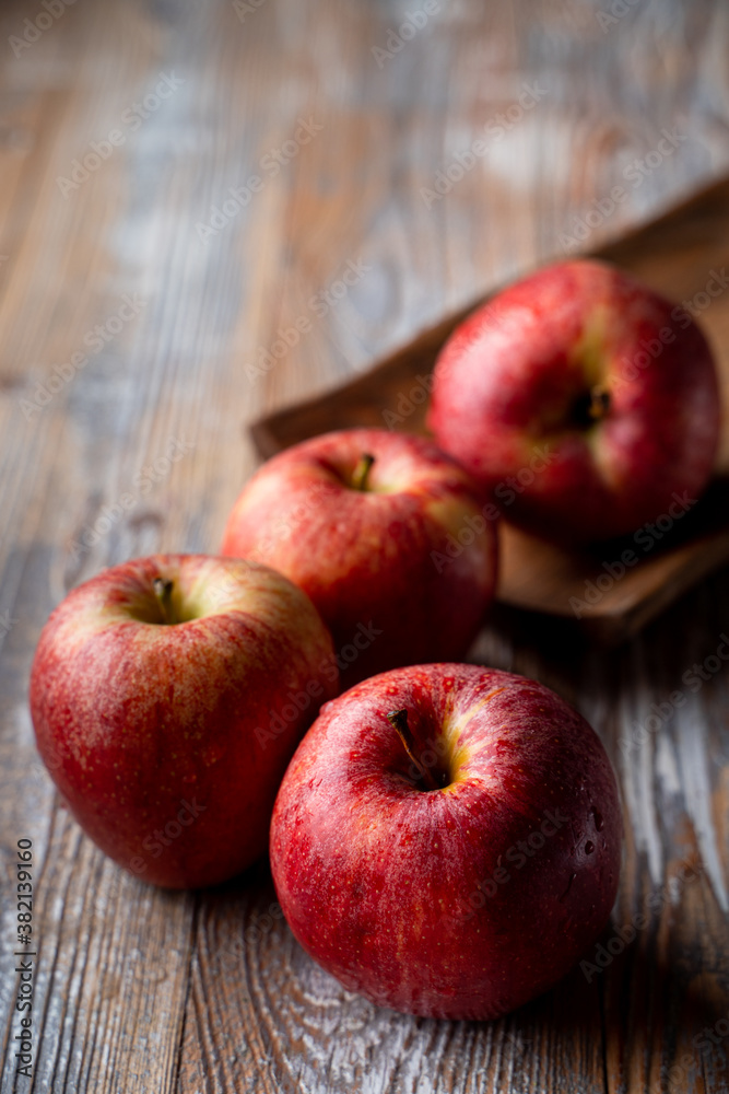 Red ruddy organic apples on rustic table close up Red ruddy organic apples on rustic table close up