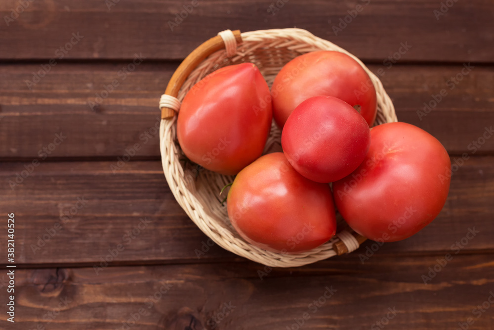 Freshly picked tomatoes on a dark wooden background. Freshly picked tomatoes on a dark wooden background.