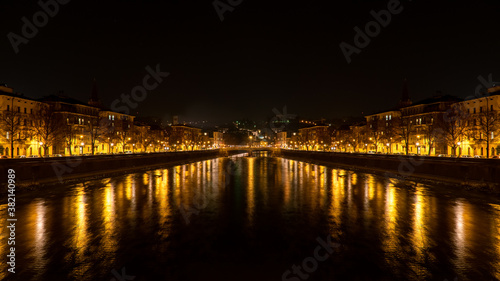 Night view of city bridge with river in old architecture building in Europe