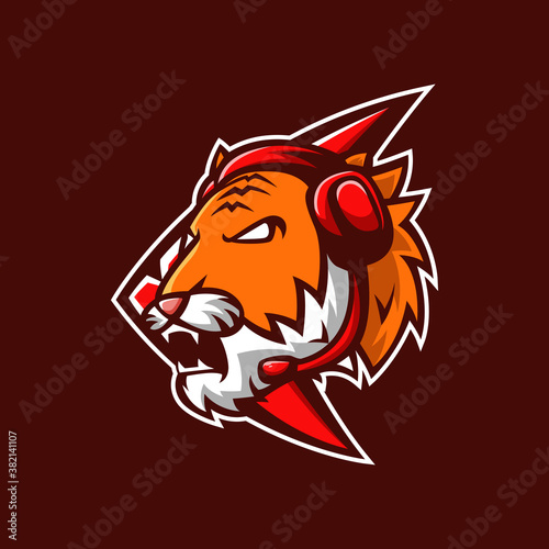 Fototapeta Naklejka Na Ścianę i Meble -  Mascot logo Tiger head esport with emblem and headphone in brown background