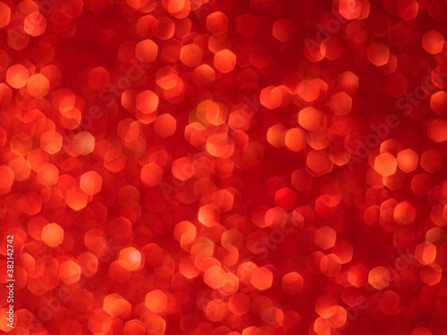 Red bokeh holiday textured glitter background. Blurred abstract holiday background.