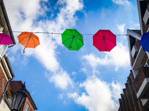 blue sky and clouds with colorful umbrellas