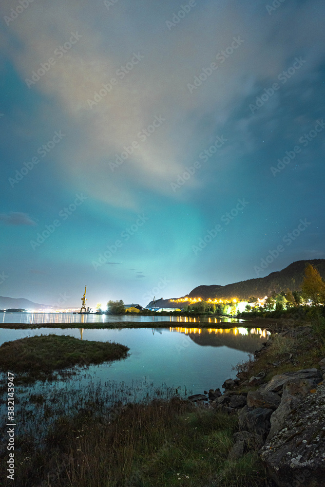 The northern lights shining over a Industrial area in Trondelag, Norway.