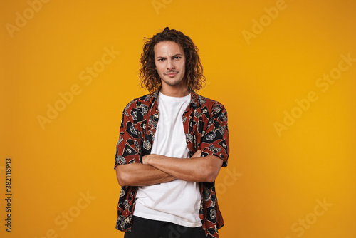 Photo of displeased handsome guy posing with arms crossed