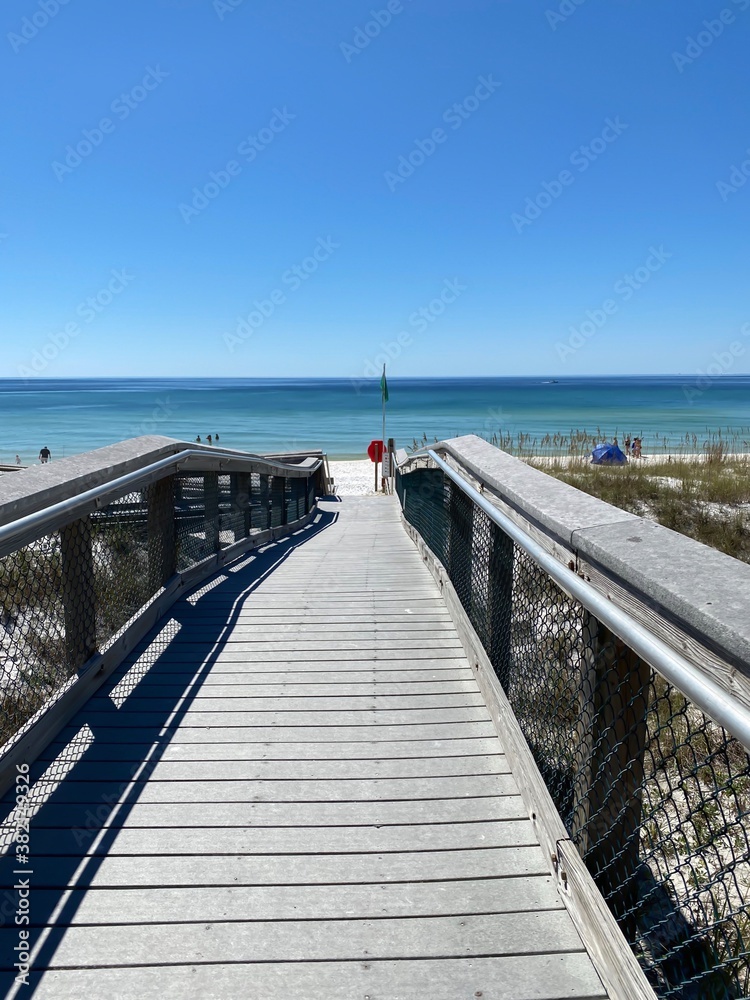 Walkway to the beach with view of emerald water Gulf of Mexico Florida 