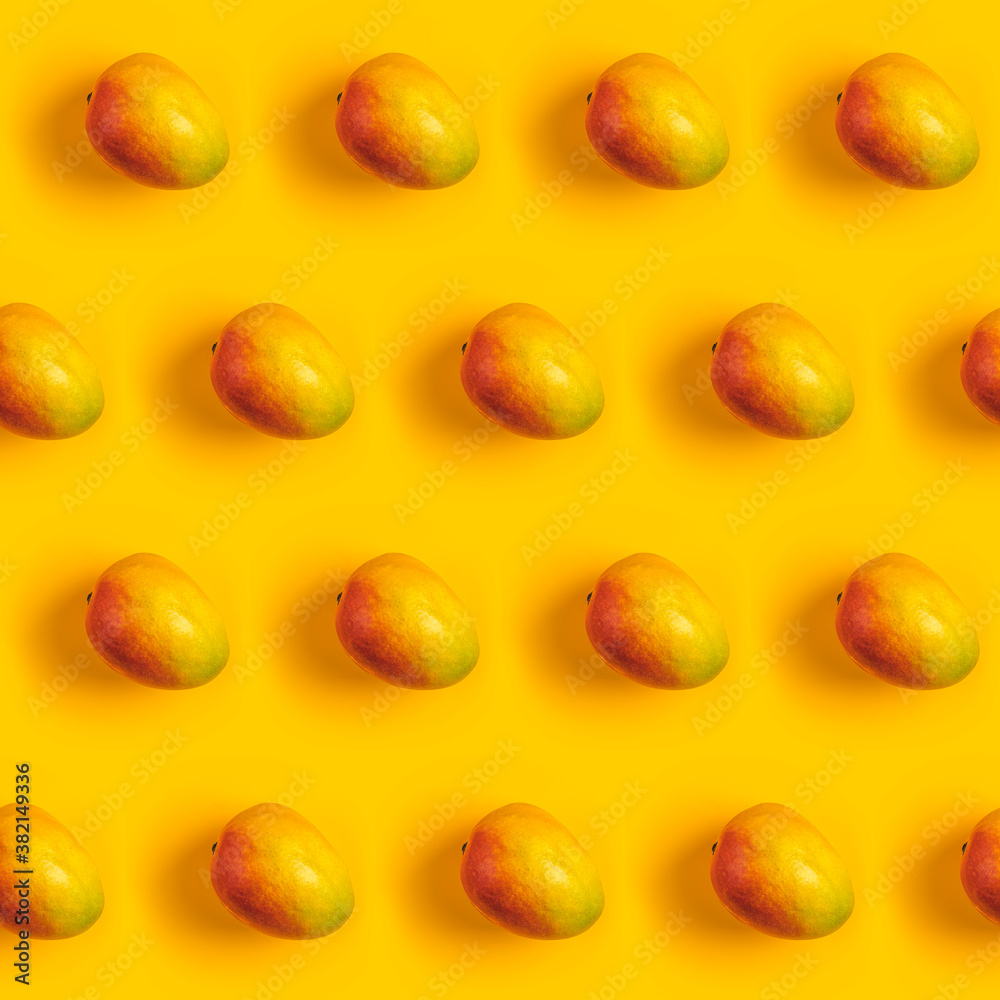 Tropical abstract background. Juicy ripe mango pattern on yellow background top. Seamless pattern with mango. Tropical abstract background. Juicy ripe mango pattern on yellow background top. Seamless pattern with mango.