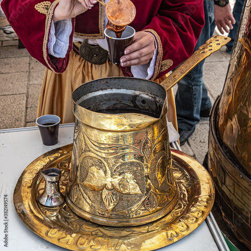 Serving Bosnian coffee from big dzezva