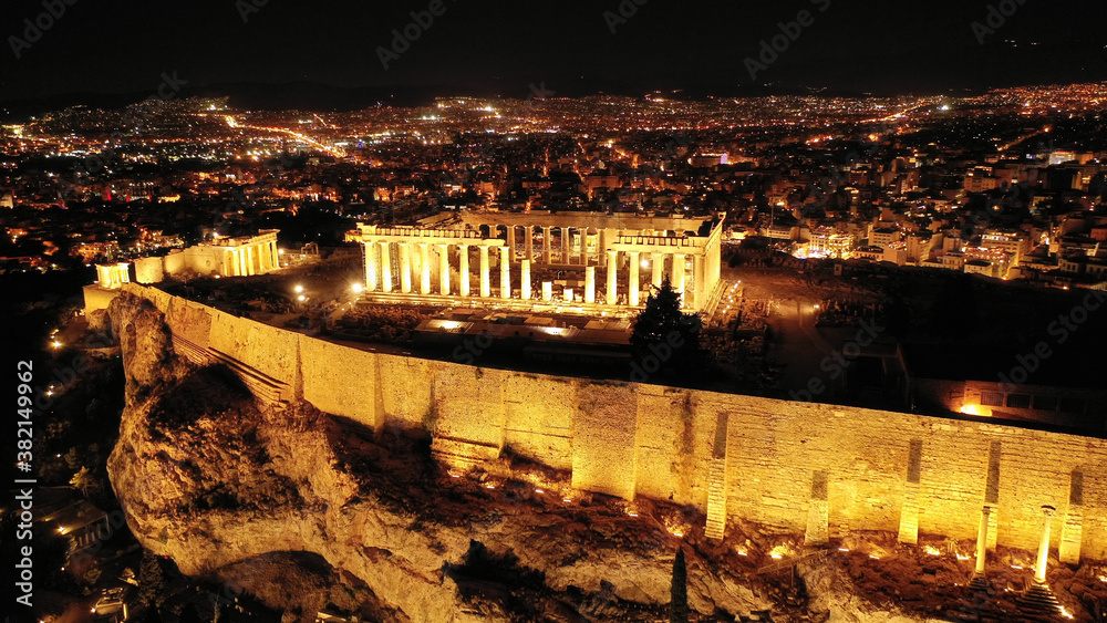 Aerial drone night shot of illuminated iconic Acropolis hill and the Parthenon, Athens, Attica, Greece