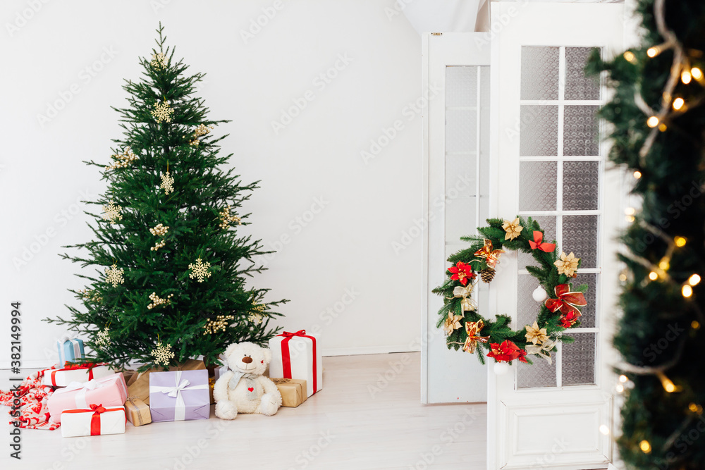Stylish Christmas scandinavian minimalistic interior Christmas tree with light and bauble in sunny living room