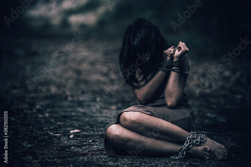 Asian hostage woman Bound with rope at night scene,The thieves kidnapped for ransom,thailand people