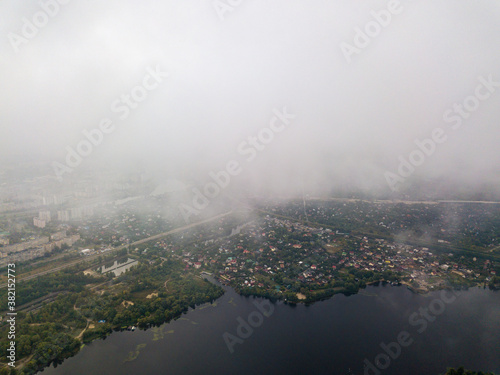 High aerial view of Kiev and the Dnieper river from under the clouds. © Sergey