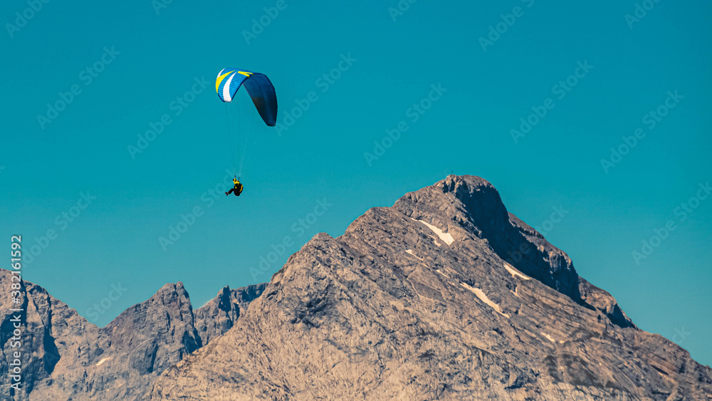 Beautiful alpine view with a paraglider at the famous Rofan summit, Maurach, Achensee, Pertisau, Tyrol, Austria Beautiful alpine view with a paraglider at the famous Rofan summit, Maurach, Achensee, Pertisau, Tyrol, Austria