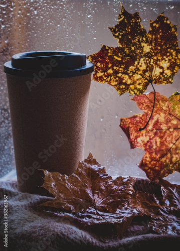 Enjoying coffee on rainy day. Coffee time on rainy day.Wet glass window and cup of hot caffeine beverage.Autumn mood.