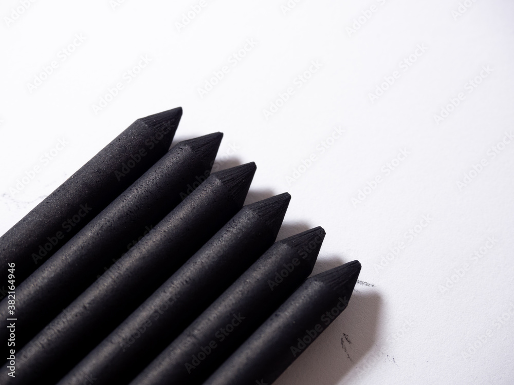 Black chalk closeup detail on white background angle view