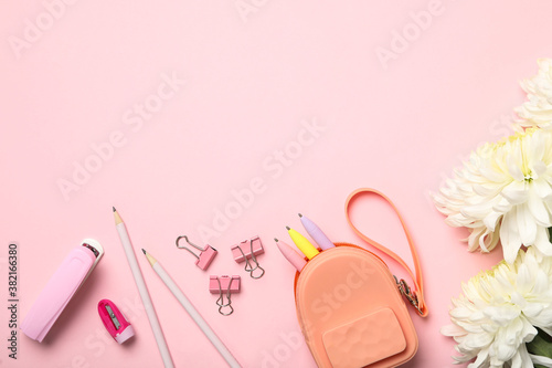Flat lay composition with flowers and stationery on pink background, space for text. Teacher's day
