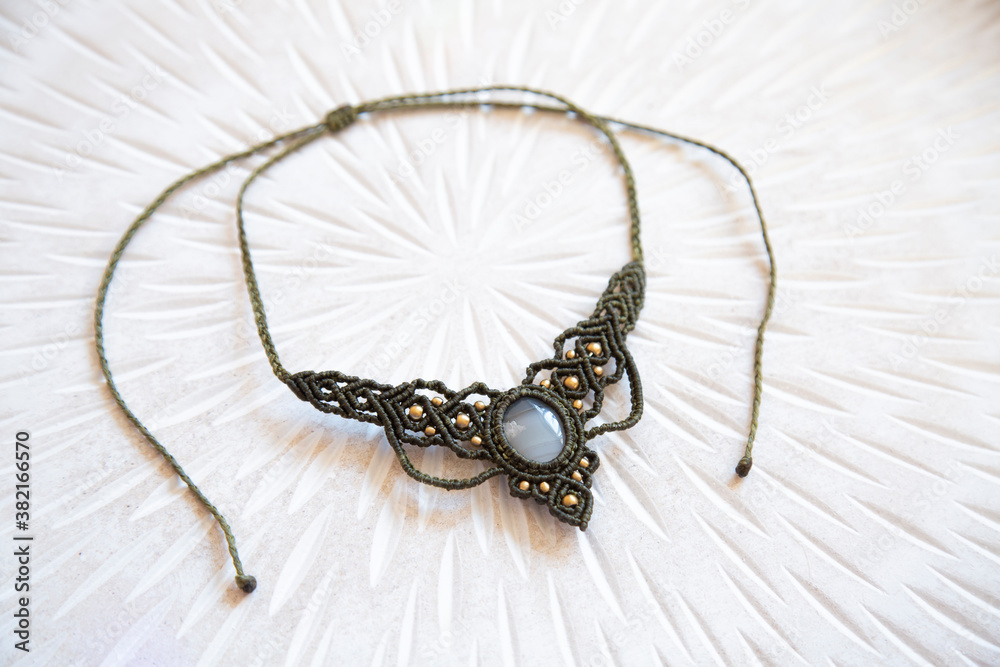 Fototapeta premium Macrame technique waxed string necklace with gemstone