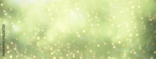 Golden green bokeh background. Holiday festive background.Abstract Christmas New Year banner