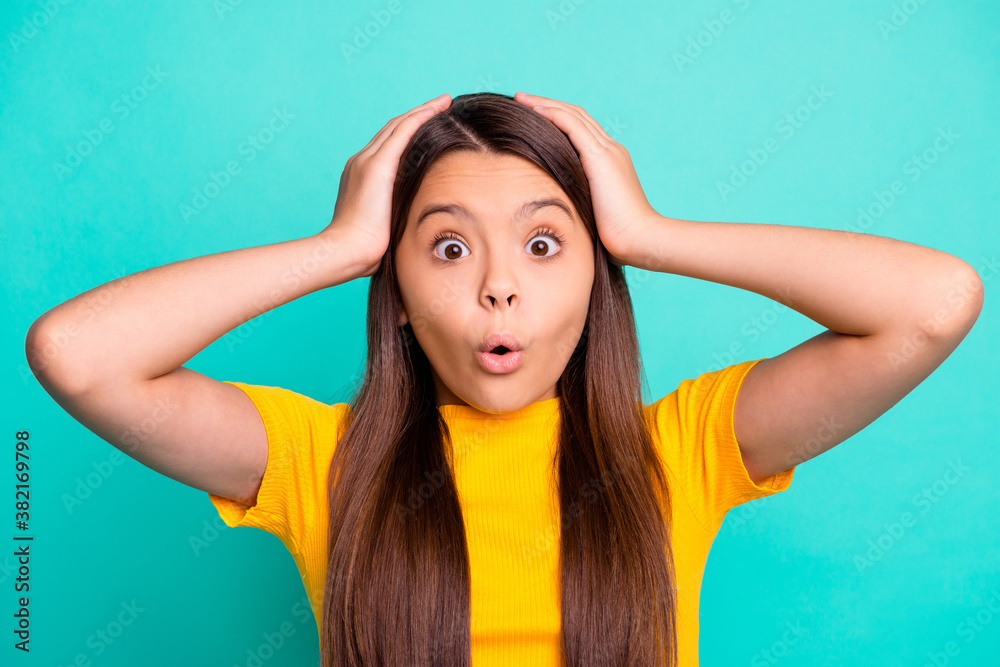 Photo of little kid girl feel astonished touch hands head wear yellow t-shirt isolated over turquoise color background Photo of little kid girl feel astonished touch hands head wear yellow t-shirt isolated over turquoise color background