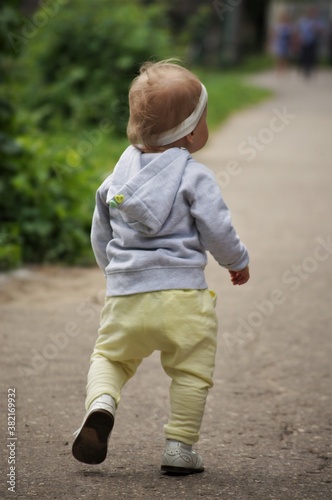 little child walking on the road