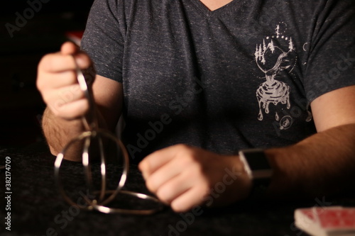 close up of a magician practicing a ring trick