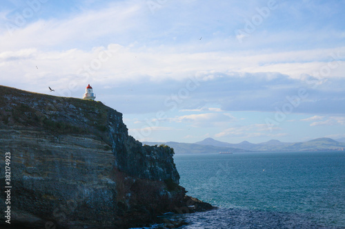 Taiaroa Head is a headland at the end of the Otago Peninsula in New Zealand, overlooking the mouth of the Otago Harbour.  photo