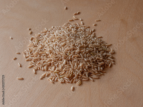 Brown rice on a plywood background