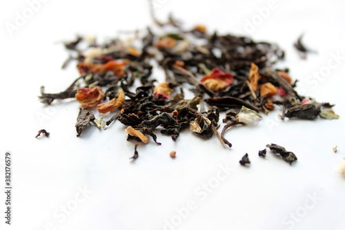 Falling dried tea leaves isolated on white background.