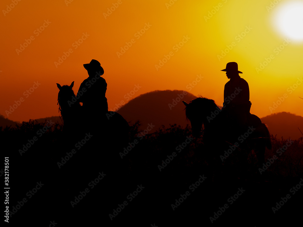 The Western Cowboy forced his horses to stop while the sun was setting, In lands where the law has not yet reached