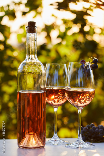 Close up of two glasses and a bottle of rose wine