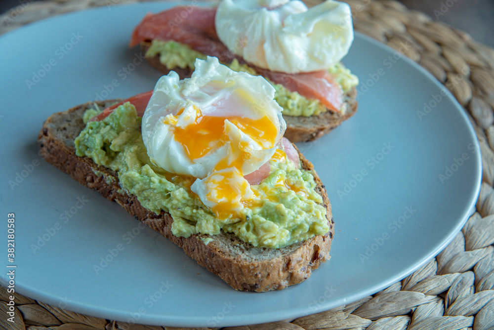 Sandwich with avocado, salmon and poached egg Sandwich with avocado, salmon and poached egg