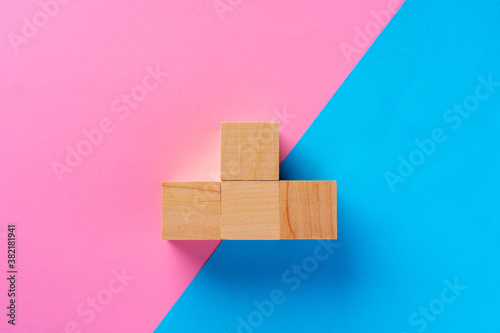 Top view photo of wooden blocks on pink and blue