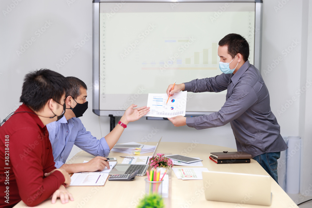 Businessmen wearing protective masks discussing and work together in meeting room. Social distance practice prevent coronavirus COVID-19. Businessmen wearing protective masks discussing and work together in meeting room. Social distance practice prevent coronavirus COVID-19.
