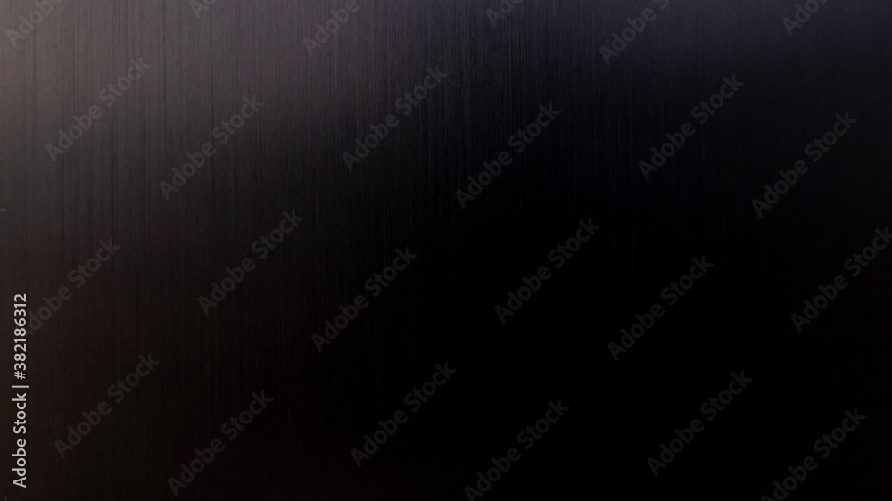Abstraction Dark metallic background. Dark brushed metal aluminum background and texture with highlights.