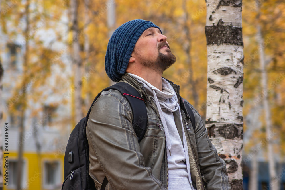 Autumn Park. A man with closed eyes, head up, in a state of calm and peace. Enjoyment of life. Autumn Park. A man with closed eyes, head up, in a state of calm and peace. Enjoyment of life.