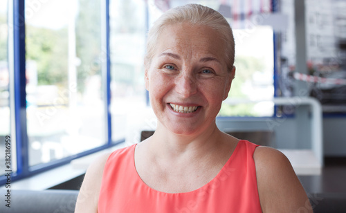 Free Download Happy beautiful middle aged woman in cafe - GFXLoad