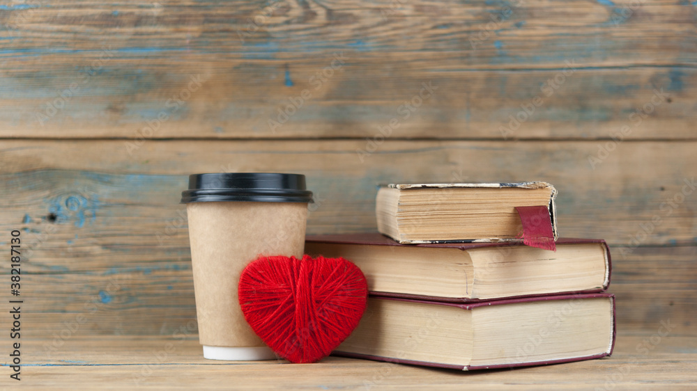 Education concept. Online education course. Books and disposable cup on wooden surface