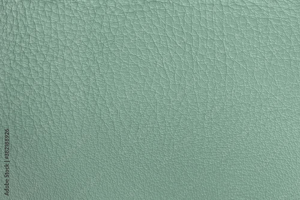 Texture of genuine leather close-up, delicate shade of salad green color, matte surface, trendy background Texture of genuine leather close-up, delicate shade of salad green color, matte surface, trendy background