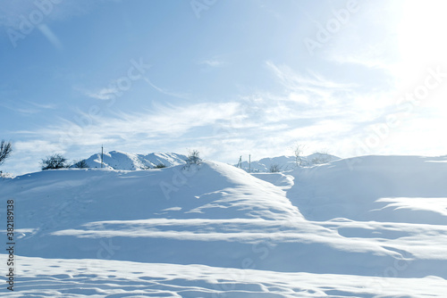 Winter snow covered hills of the Tien Shan mountains in Uzbekistan in clear Sunny weather © Sunshine