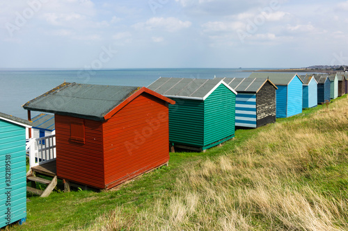 Traditional colorful English beach huts in Whitstable, Kent in the United Kingdom