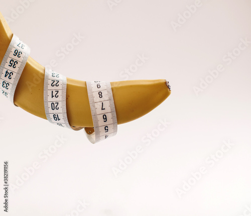 Yellow banana, with measuring tape indicate male's penis length, or men's health. It also indicate food for fitness & diet.
