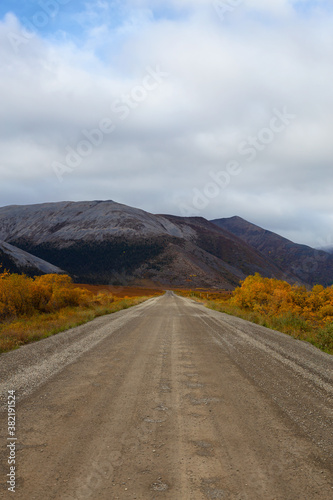 View of Scenic Road and Mountains on a Fall Day in Canadian Nature. Taken near Tombstone Territorial Park, Yukon, Canada.
