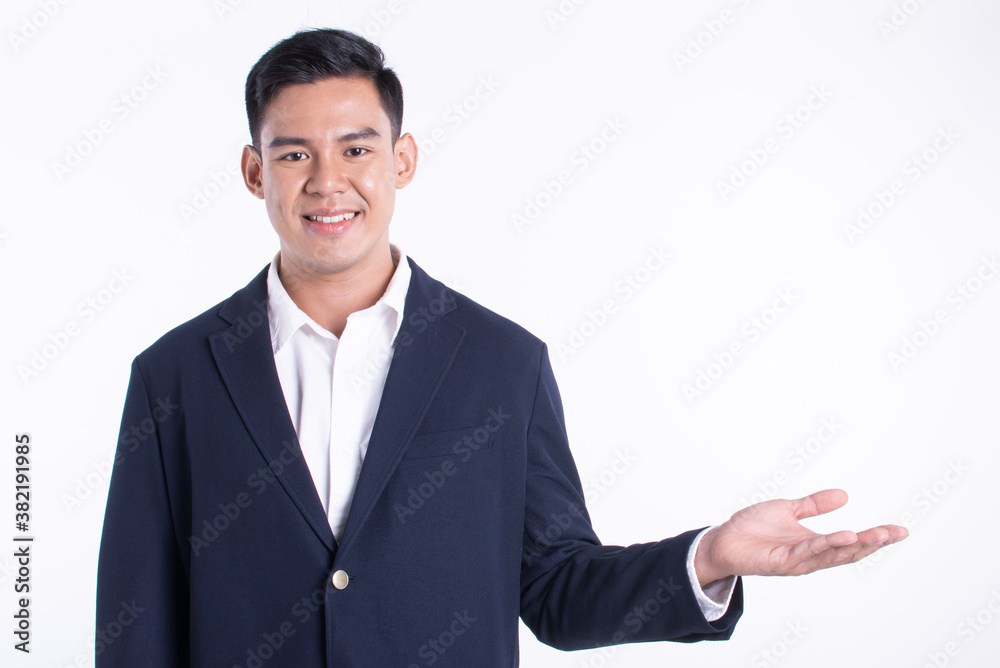 Portrait of asian business man making gesture of preseting and standing on white background Portrait of asian business man making gesture of preseting and standing on white background