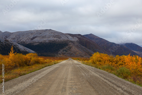 View of Scenic Road and Mountains on a Fall Day in Canadian Nature. Taken near Tombstone Territorial Park, Yukon, Canada.